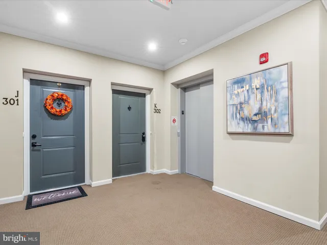 a view of an empty room with a painting on the wall