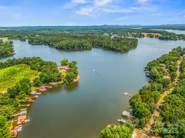 an aerial view of lake and residential houses with outdoor space