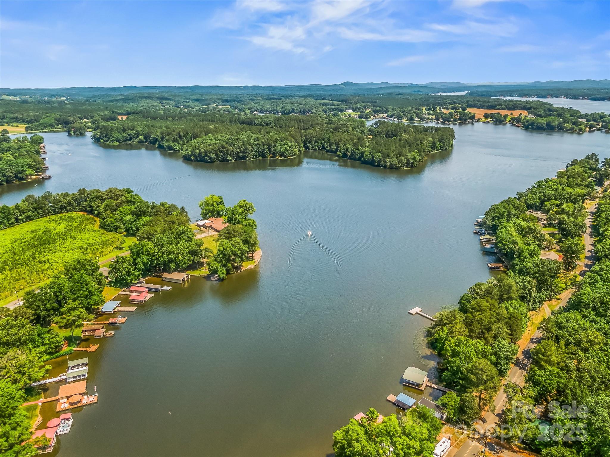 188 Nicks Road, Unit 20/21 Norwood, NC 28128 - Photo 1 of 20 an aerial view of lake and residential houses with outdoor space