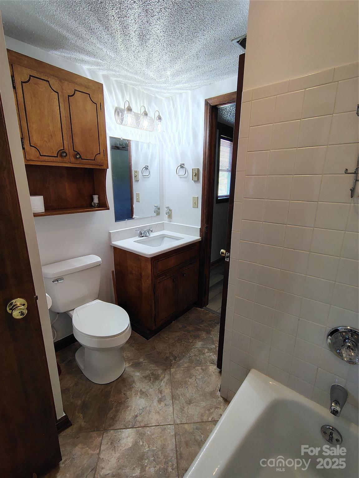 188 Nicks Road, Unit 20/21 Norwood, NC 28128 - Photo 11 of 20 a bathroom with a sink toilet and mirror