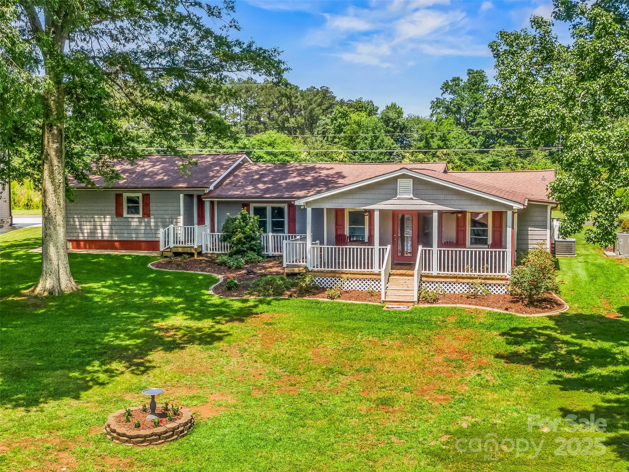 188 Nicks Road, Unit 20/21 Norwood, NC 28128 - Photo 14 of 20 a view of a house with a yard and sitting area