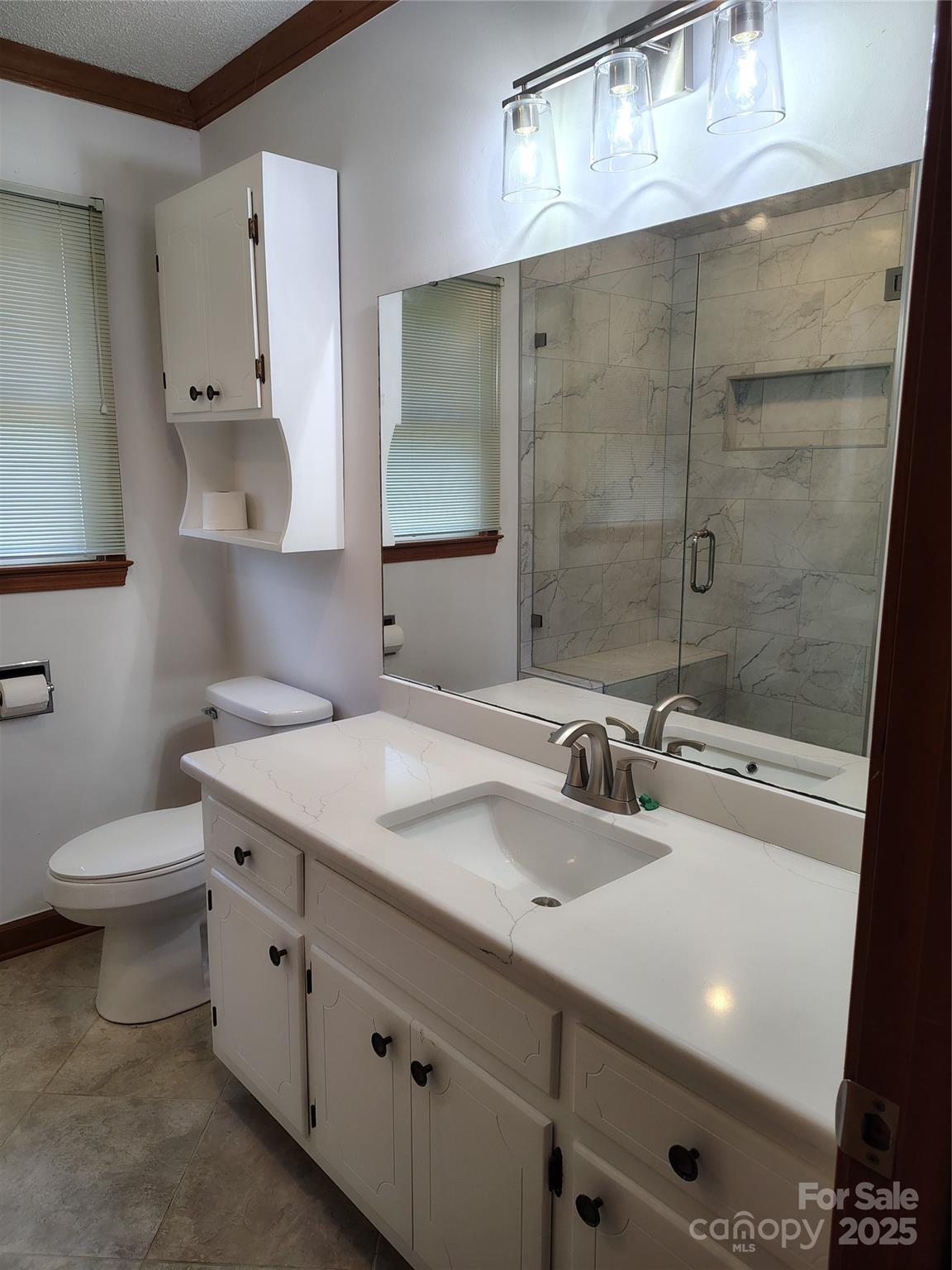188 Nicks Road, Unit 20/21 Norwood, NC 28128 - Photo 9 of 20 a bathroom with a sink a toilet and shower