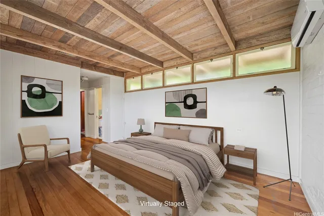 a bedroom with a bed and a dresser next to a window