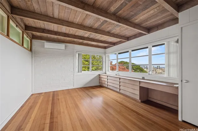 a view of room with window and wooden floor