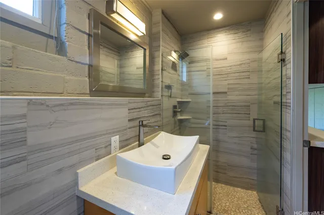 a bathroom with a sink a toilet and shower