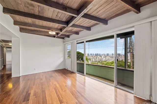 a view of a room with wooden floor and a window