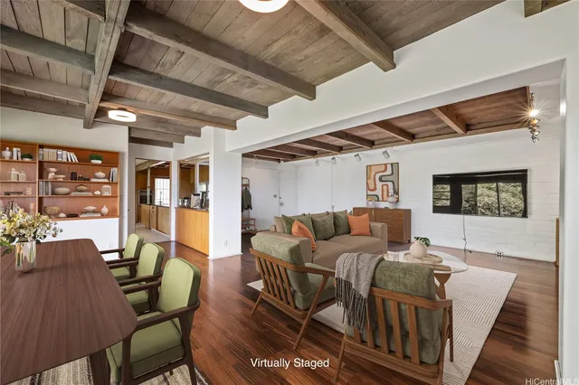 a living room with furniture a ceiling fan and a rug