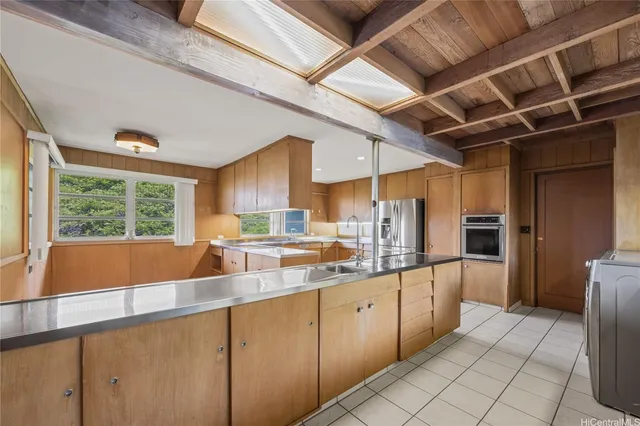 a kitchen with a sink window and refrigerator