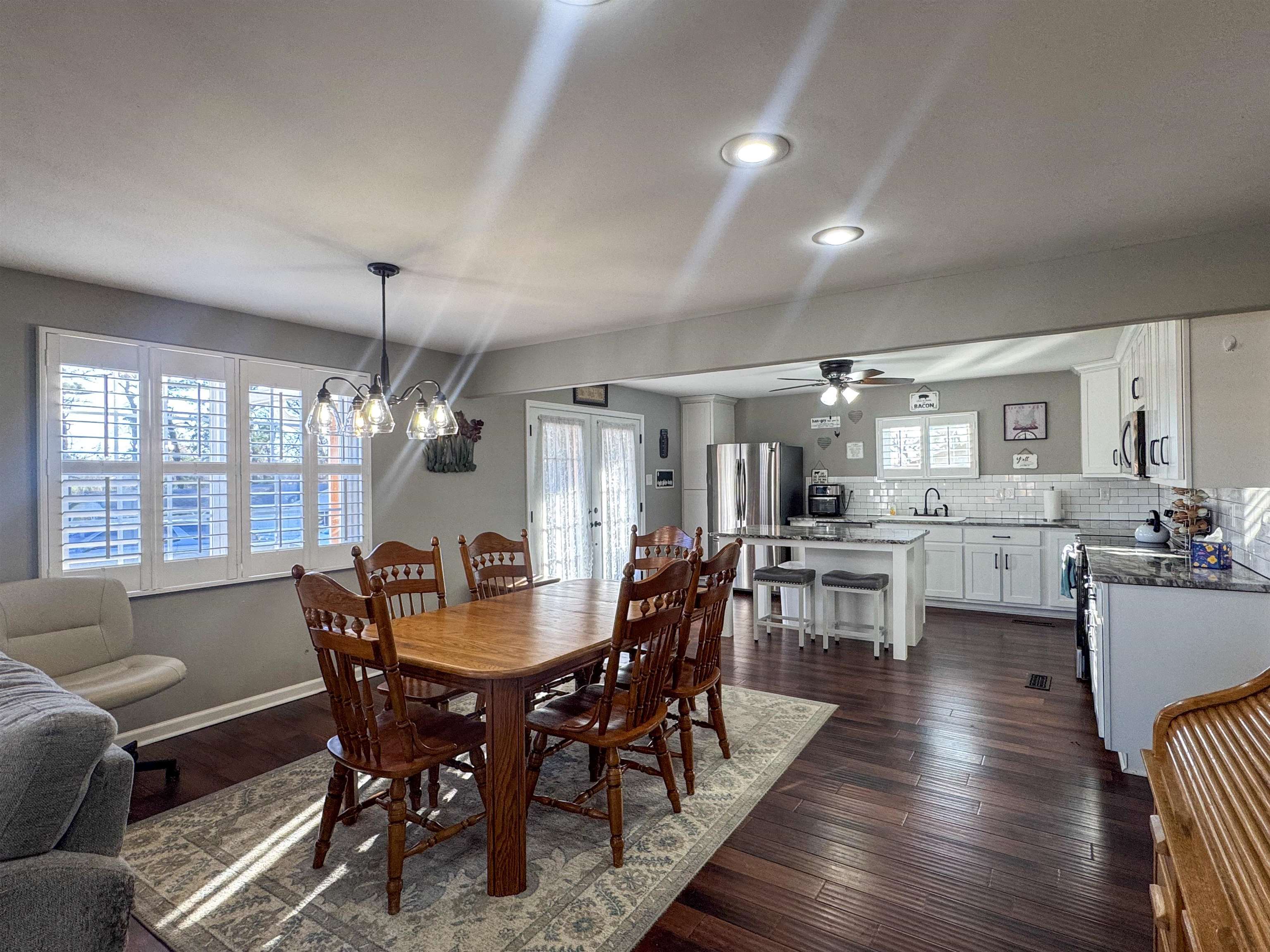 792 Smith Drive Covington, TN 38019 - Photo 14 of 34 Dining space featuring dark wood finished floors, a chandelier, and ceiling fan