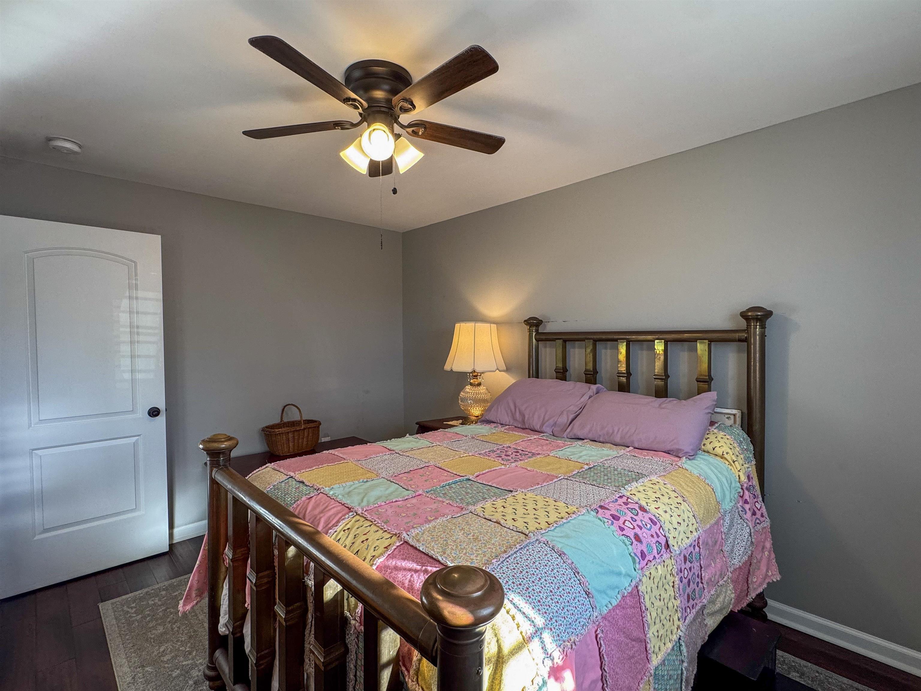792 Smith Drive Covington, TN 38019 - Photo 19 of 34 a bedroom with a bed and a chandelier