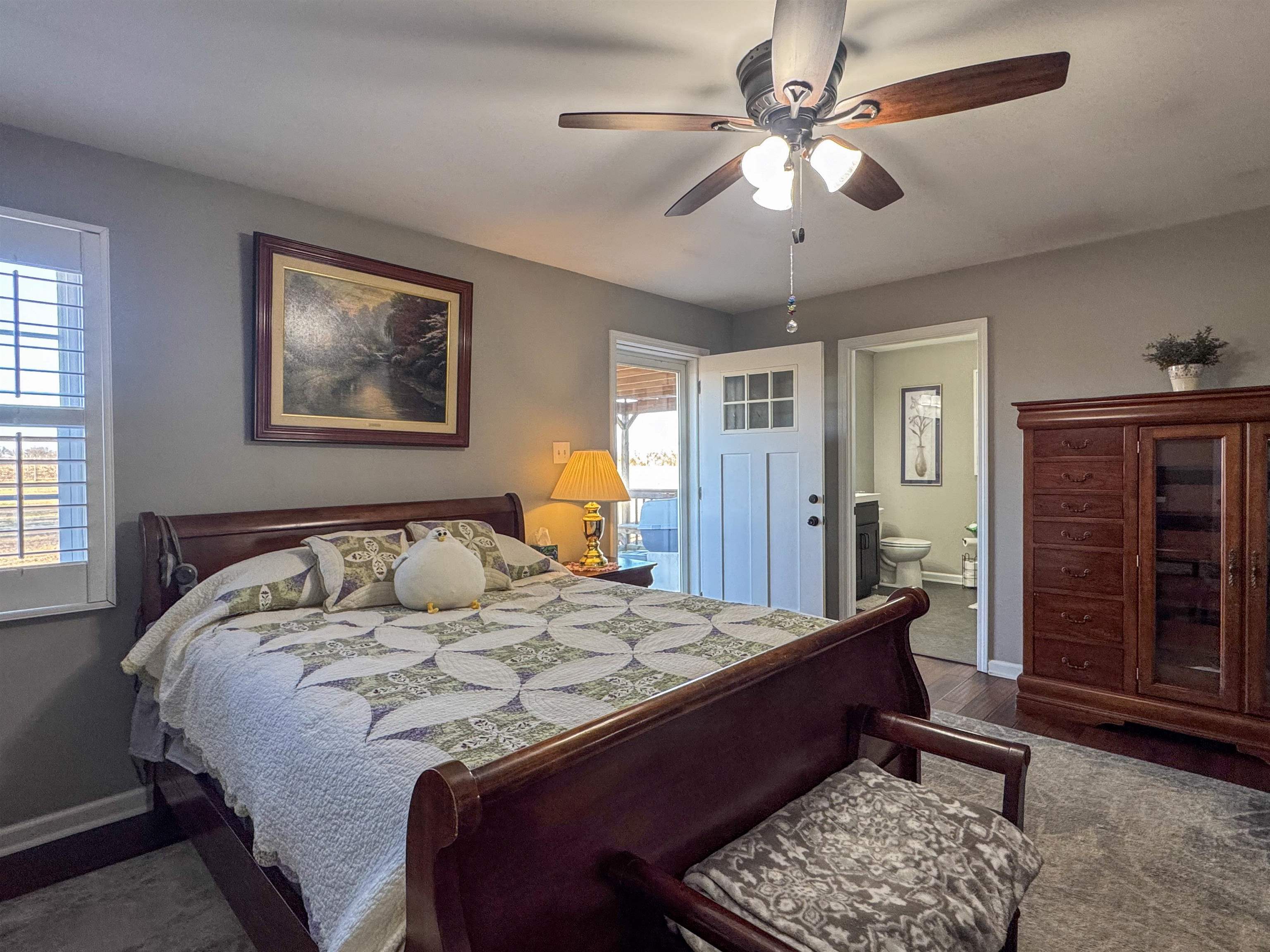 792 Smith Drive Covington, TN 38019 - Photo 21 of 34 Bedroom featuring a ceiling fan, dark wood finished floors, and connected bathroom