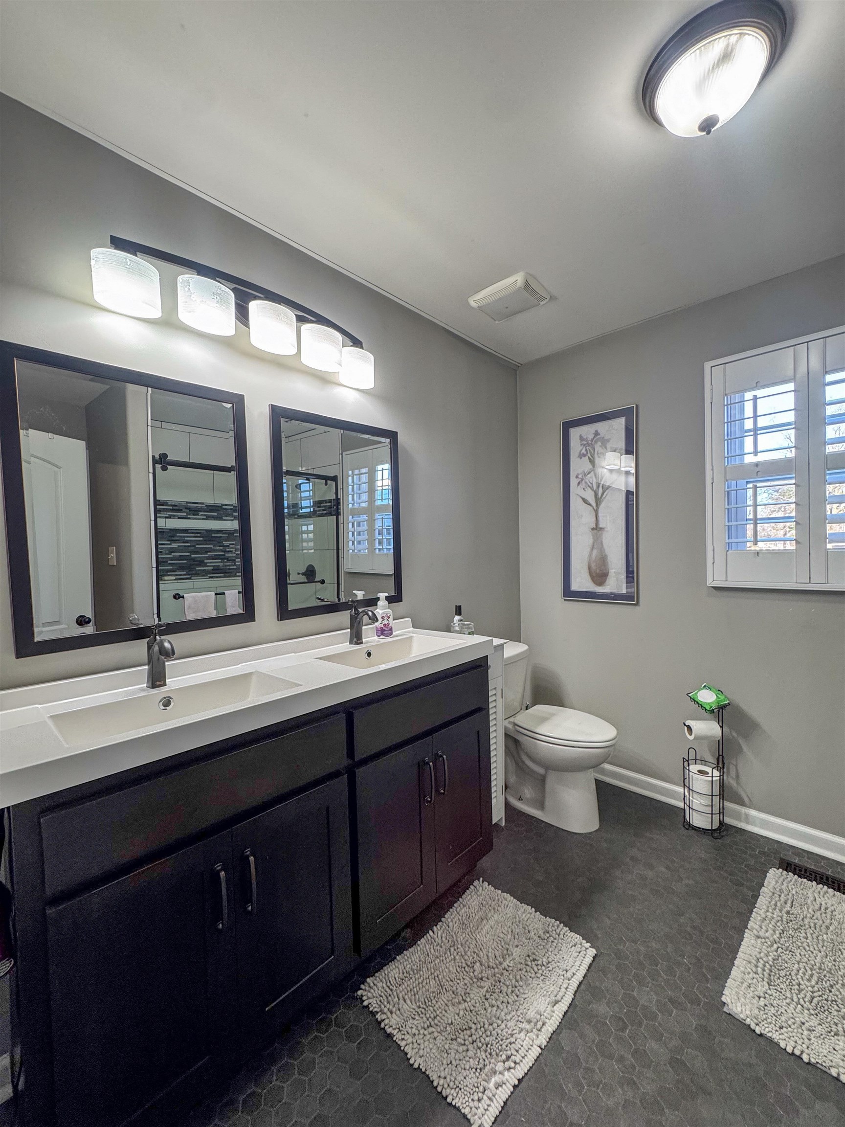 792 Smith Drive Covington, TN 38019 - Photo 23 of 34 a spacious bathroom with a double vanity sink a large mirror and toilet