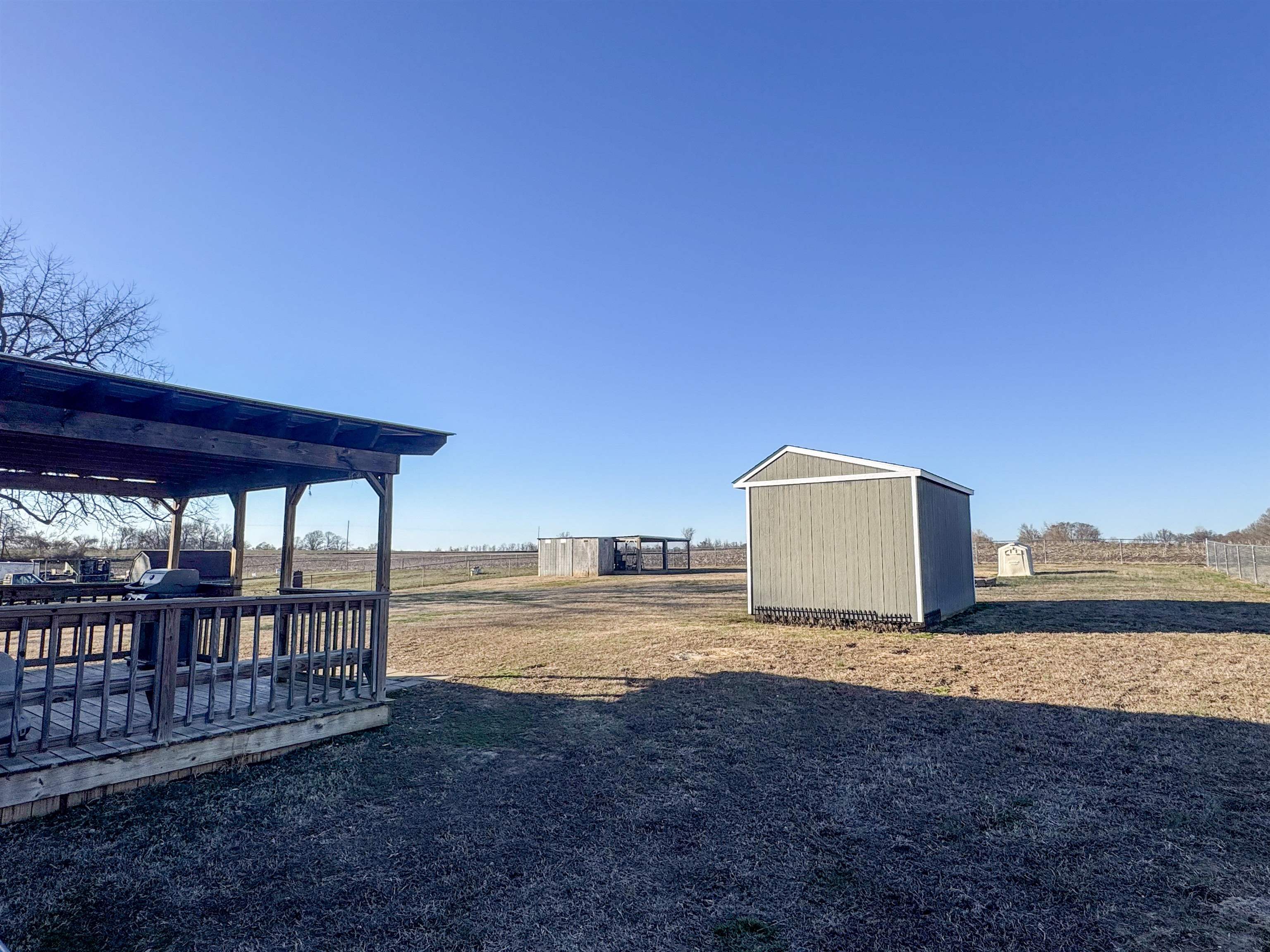 792 Smith Drive Covington, TN 38019 - Photo 5 of 34 View of yard with a wooden deck and an outbuilding