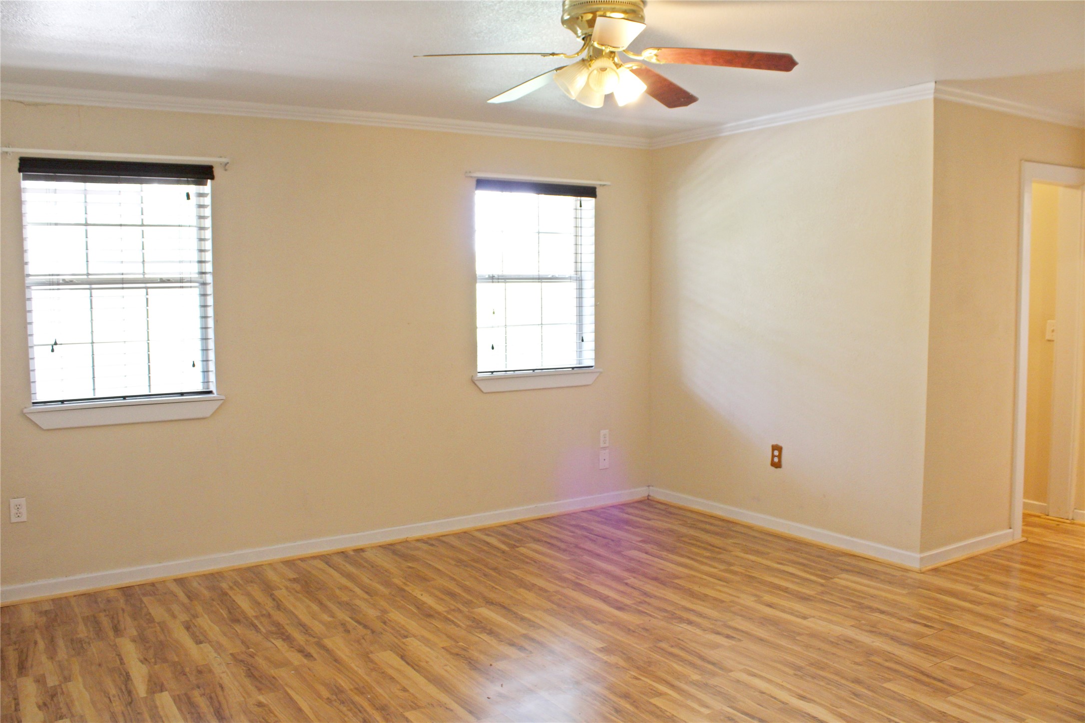2042 Willow Springs Road Fayetteville, TX 78940 - Photo 16 of 42 a view of an empty room with wooden floor and a window