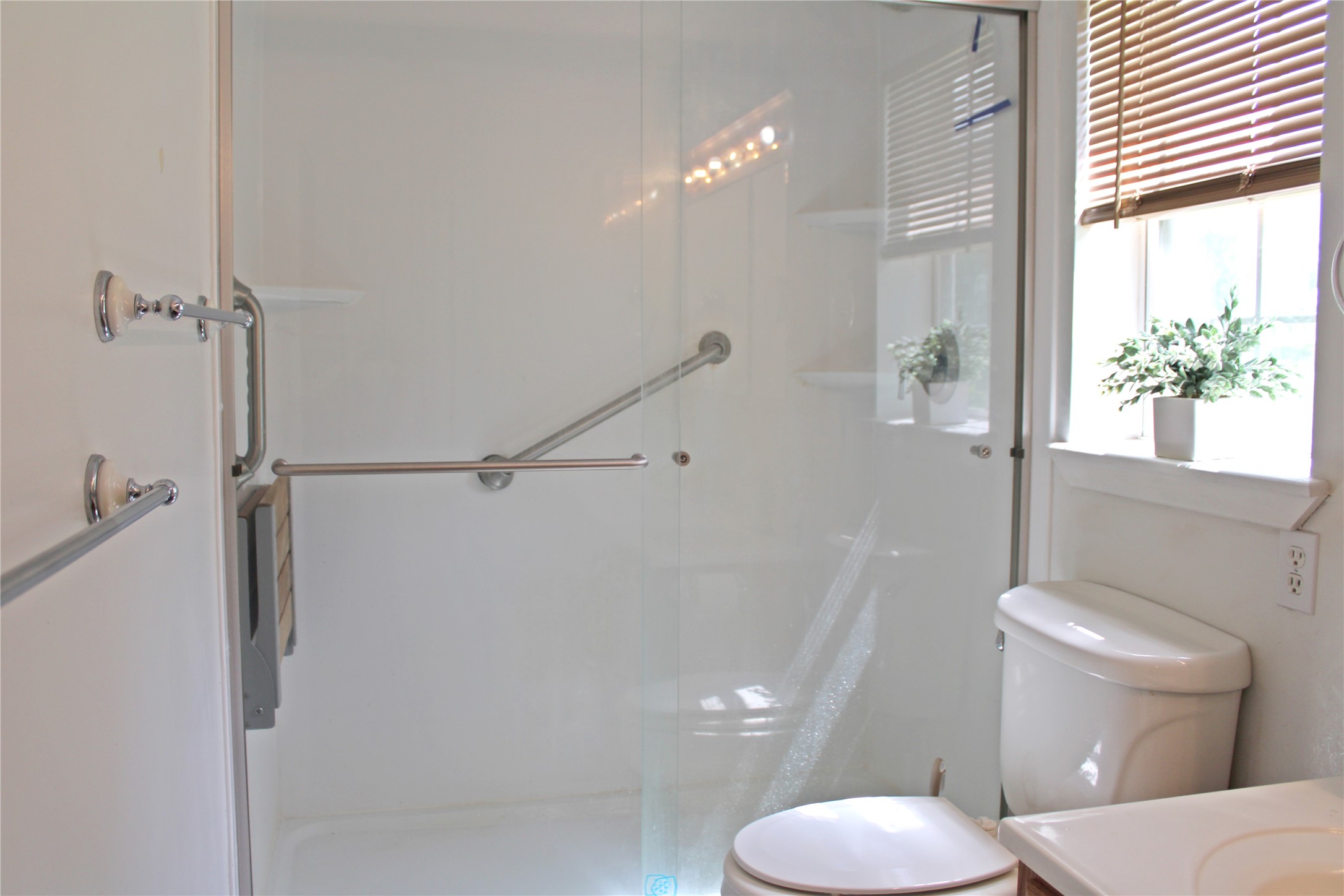 2042 Willow Springs Road Fayetteville, TX 78940 - Photo 19 of 42 a white toilet sitting next to a bathroom sink and a shower