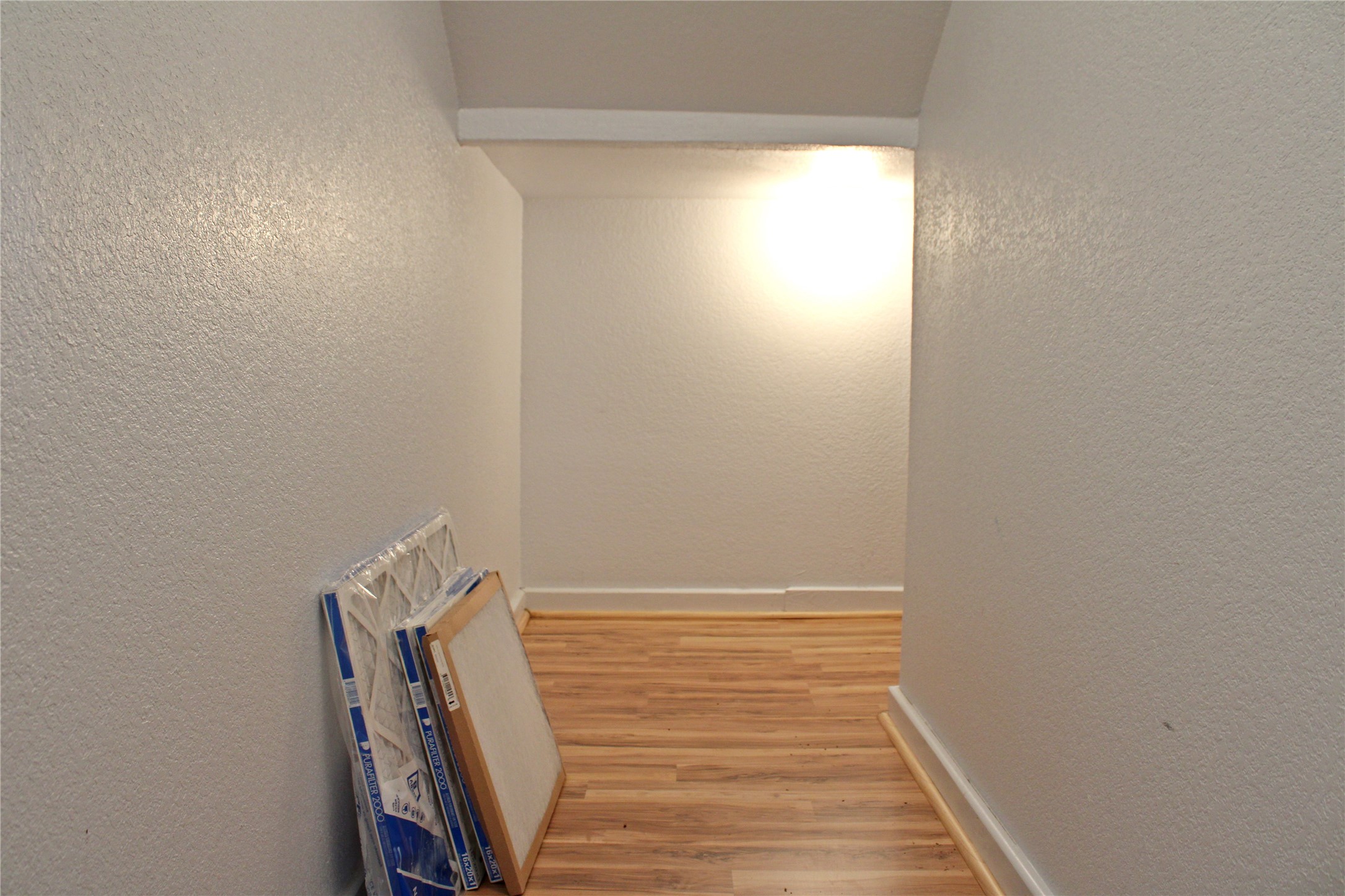 2042 Willow Springs Road Fayetteville, TX 78940 - Photo 33 of 42 a view of a room with wooden floor and white wall