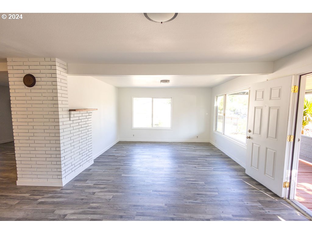 440 Wilkie Street Eugene, OR 97402 - Photo 12 of 38 a view of an empty room with wooden floor and a window