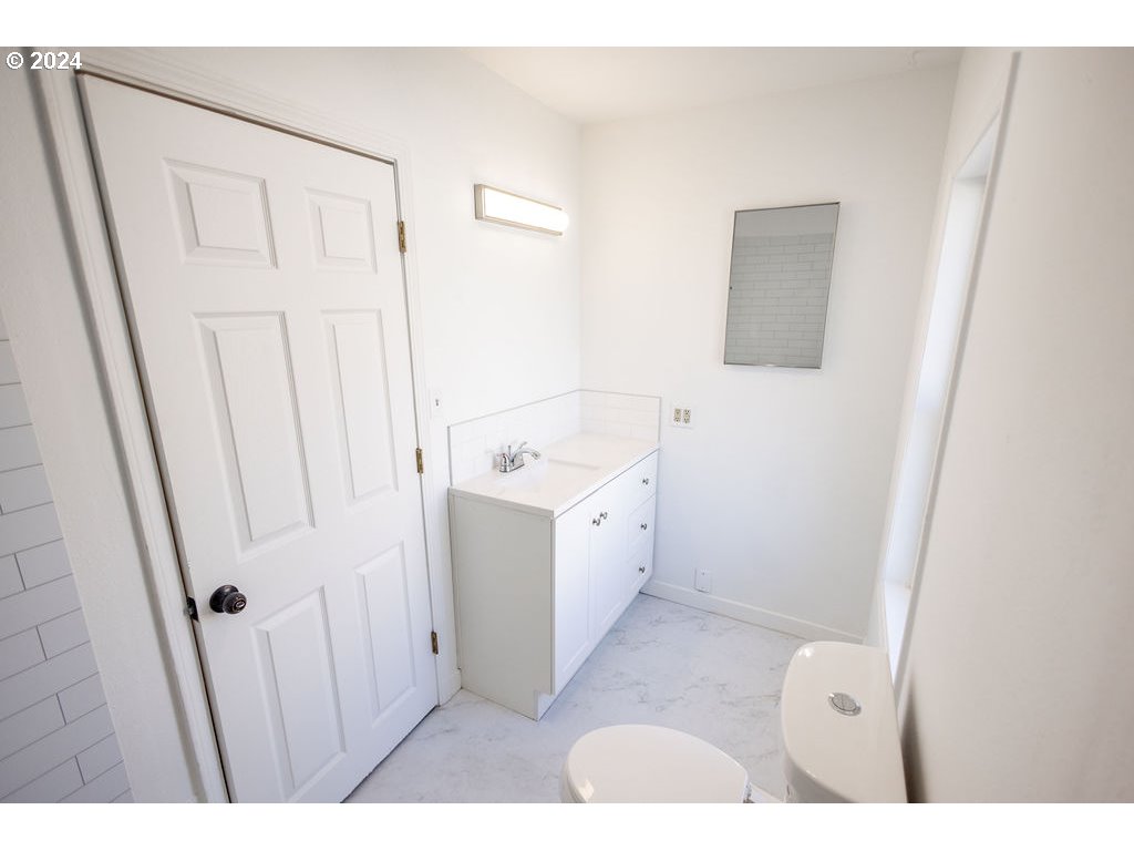 440 Wilkie Street Eugene, OR 97402 - Photo 16 of 38 a bathroom with a sink a toilet and a mirror