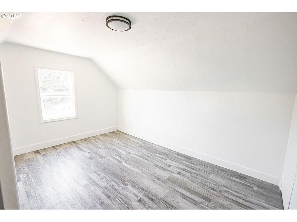 440 Wilkie Street Eugene, OR 97402 - Photo 26 of 38 a view of an empty room with wooden floor and a window