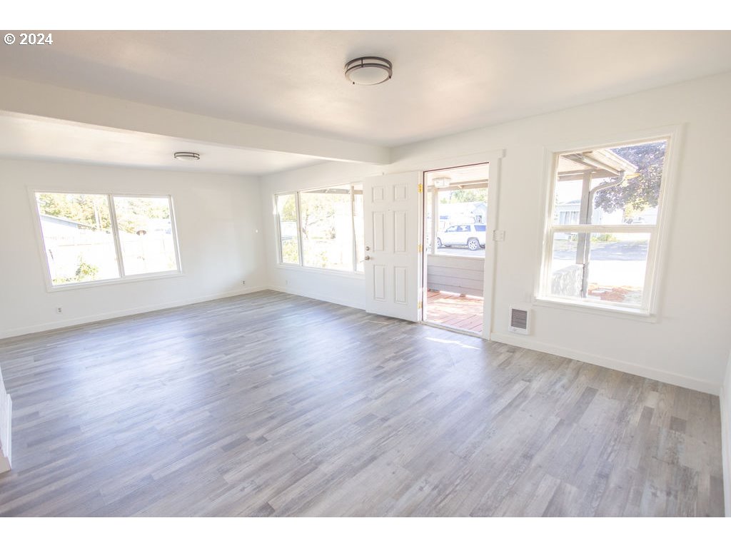 440 Wilkie Street Eugene, OR 97402 - Photo 10 of 38 a view of an empty room with wooden floor and window