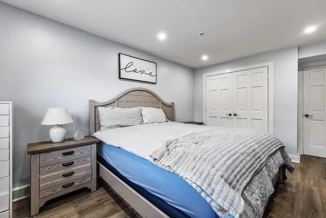 a bedroom with a bed and a lamp