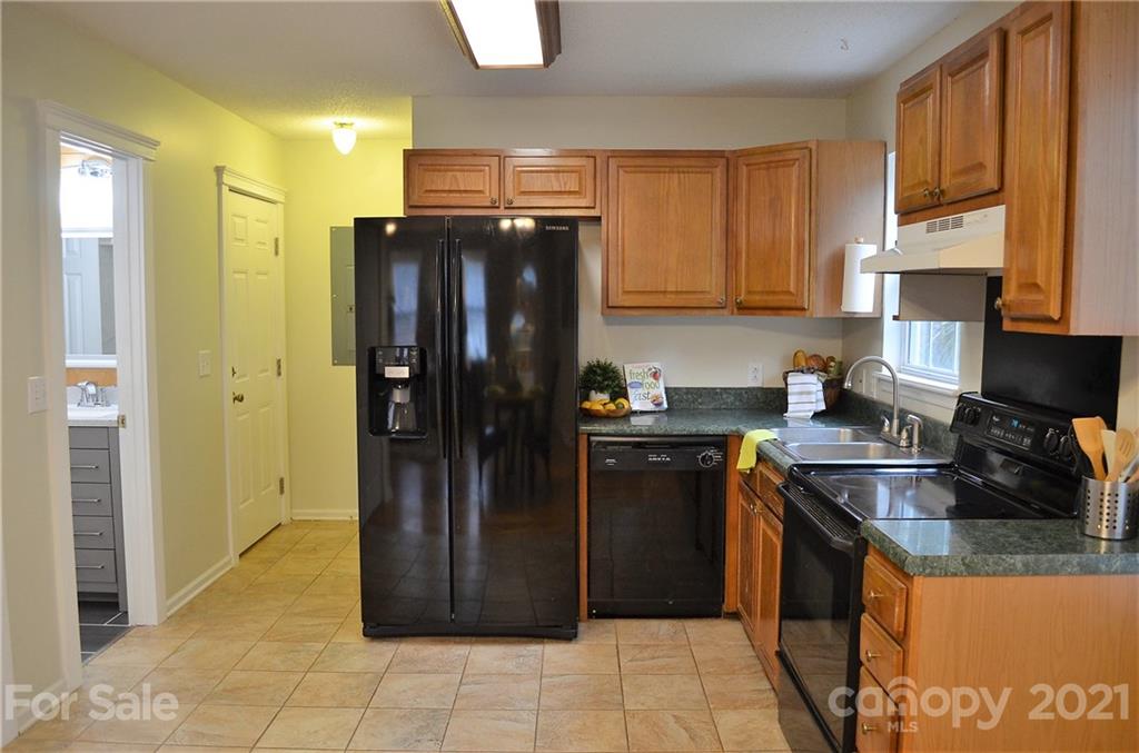 7610 Sarah Drive Denver, NC 28037 - Photo 12 of 48 a kitchen with stainless steel appliances granite countertop a refrigerator and a stove
