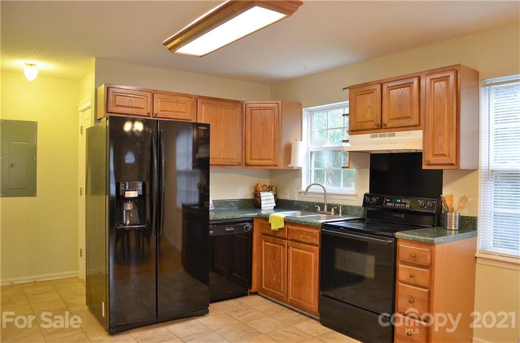 7610 Sarah Drive Denver, NC 28037 - Photo 14 of 48 a kitchen with granite countertop a refrigerator stove and sink