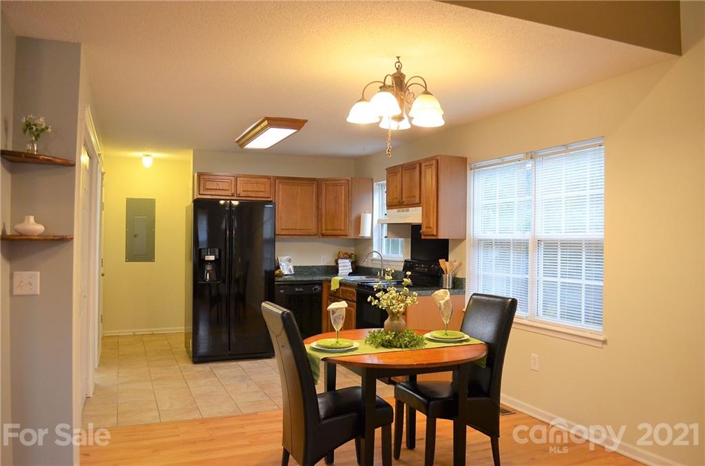7610 Sarah Drive Denver, NC 28037 - Photo 16 of 48 a view of a dining room with furniture and a chandelier
