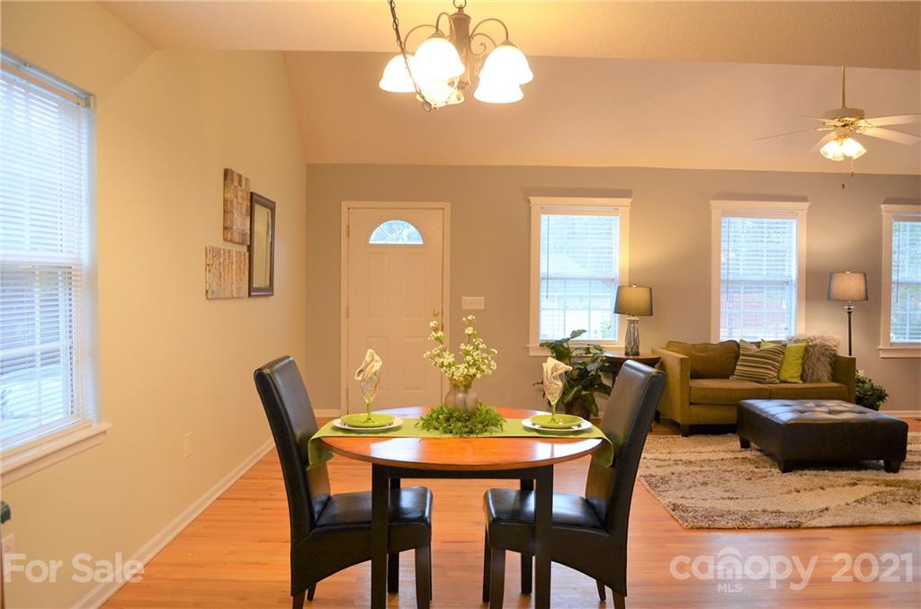 7610 Sarah Drive Denver, NC 28037 - Photo 18 of 48 a view of a dining room with furniture and wooden floor