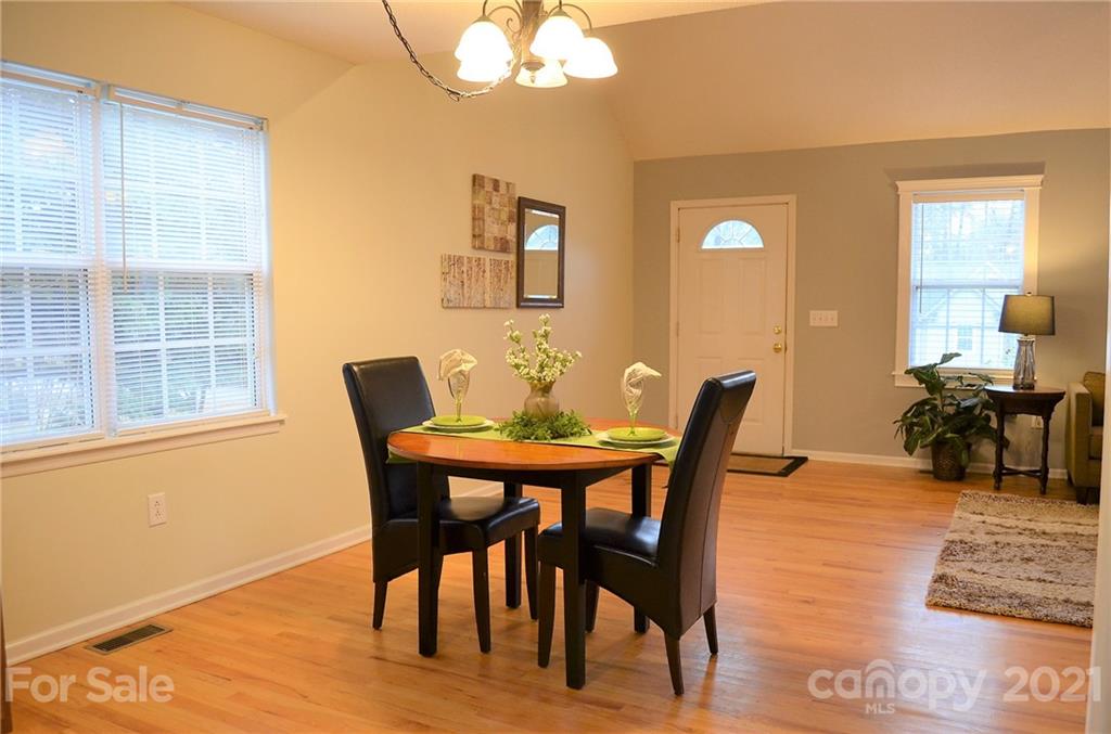 7610 Sarah Drive Denver, NC 28037 - Photo 19 of 48 a dining room with furniture and wooden floor