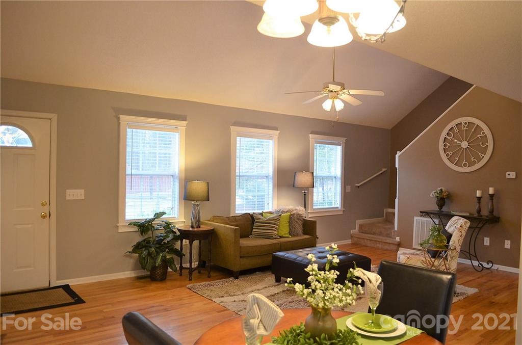 7610 Sarah Drive Denver, NC 28037 - Photo 20 of 48 a living room with furniture chandelier and a mirror