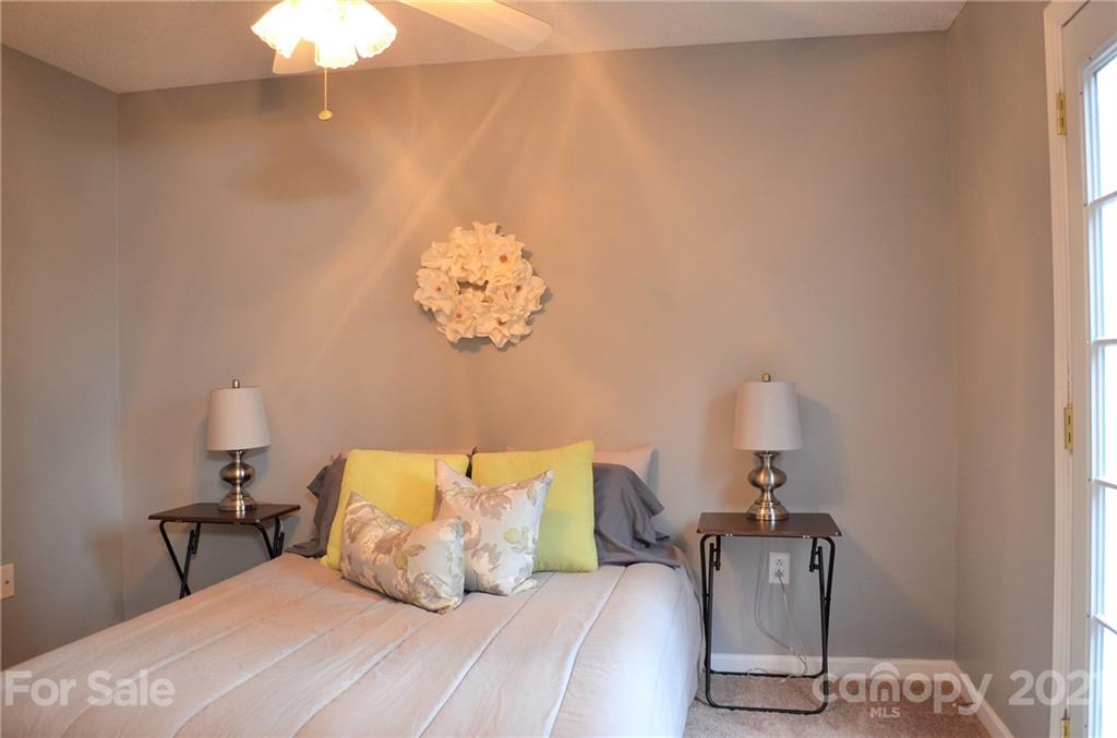 7610 Sarah Drive Denver, NC 28037 - Photo 21 of 48 a bedroom with a bed and wooden floor