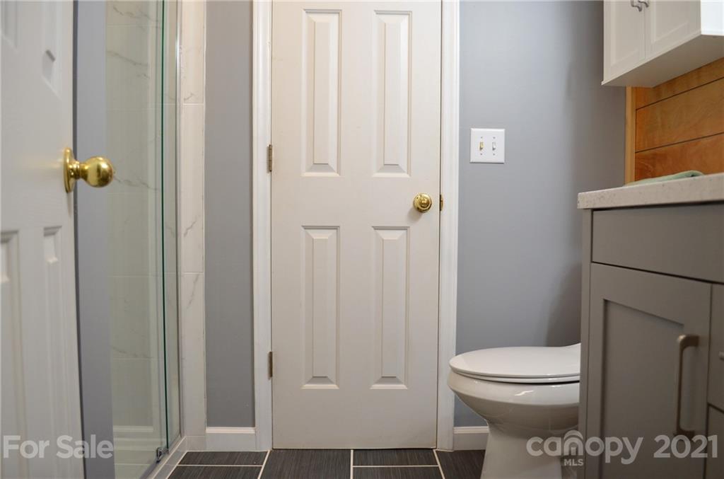 7610 Sarah Drive Denver, NC 28037 - Photo 25 of 48 a bathroom with a toilet and a shower