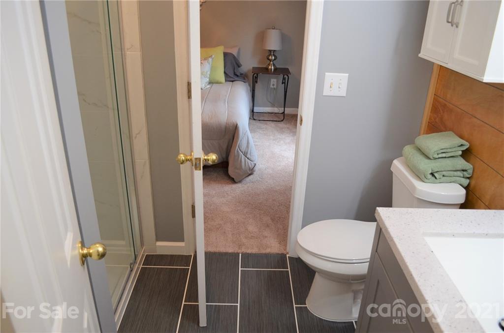 7610 Sarah Drive Denver, NC 28037 - Photo 27 of 48 a bathroom with a toilet and a shower