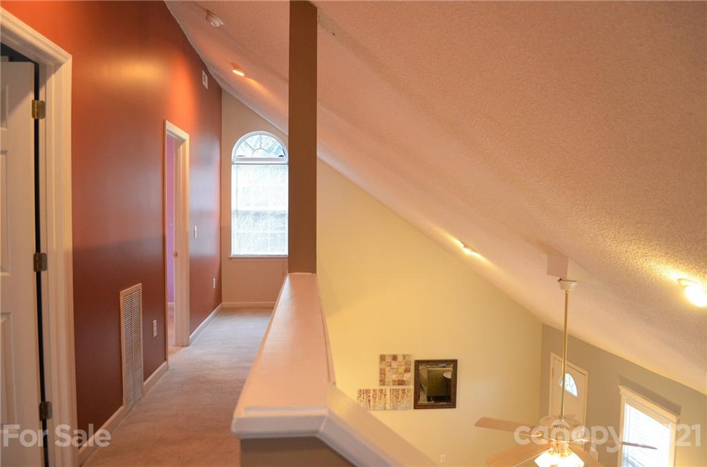 7610 Sarah Drive Denver, NC 28037 - Photo 29 of 48 a view of a hallway with windows
