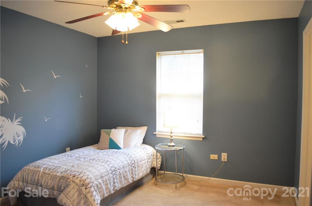 7610 Sarah Drive Denver, NC 28037 - Photo 31 of 48 a bedroom with a bed and a window