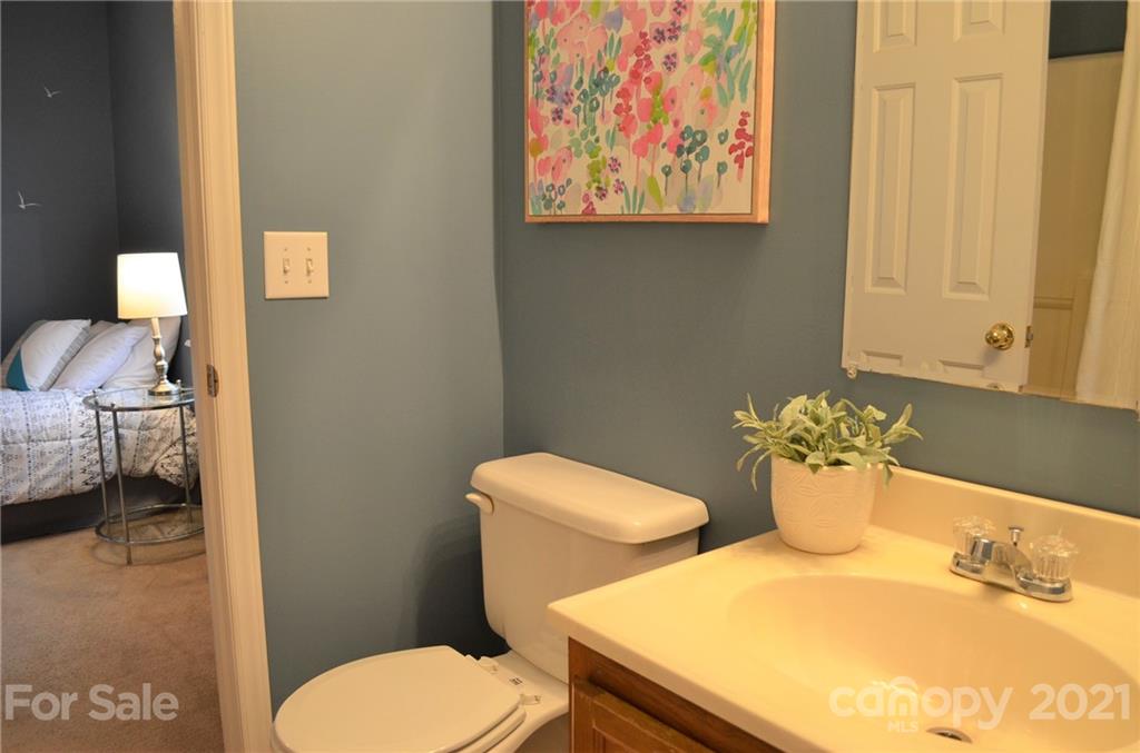 7610 Sarah Drive Denver, NC 28037 - Photo 35 of 48 a bathroom with a toilet sink and mirror