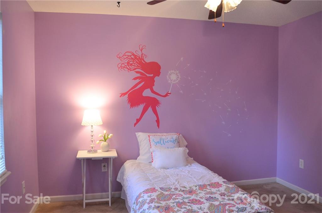 7610 Sarah Drive Denver, NC 28037 - Photo 39 of 48 a bedroom with a bed and a table