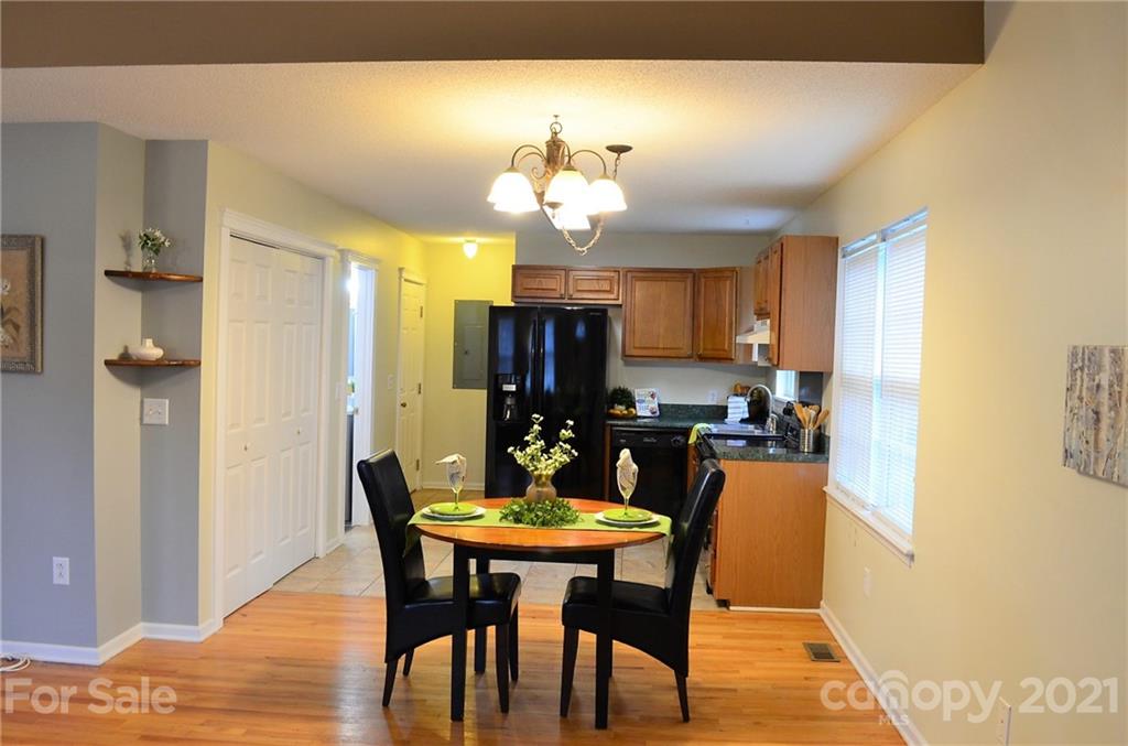 7610 Sarah Drive Denver, NC 28037 - Photo 5 of 48 a view of a dining room with furniture and chandelier
