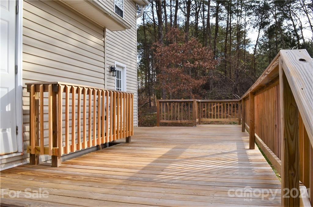 7610 Sarah Drive Denver, NC 28037 - Photo 41 of 48 a view of a balcony with wooden floor and fence and a floor to ceiling window