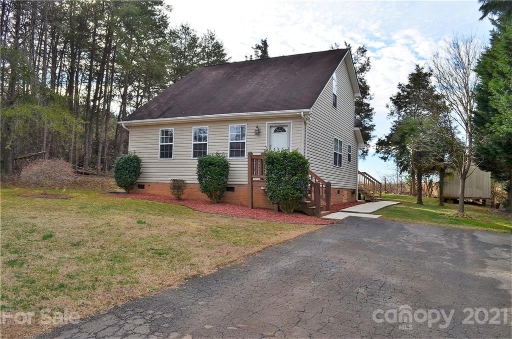 7610 Sarah Drive Denver, NC 28037 - Photo 48 of 48 a front view of a house with garden