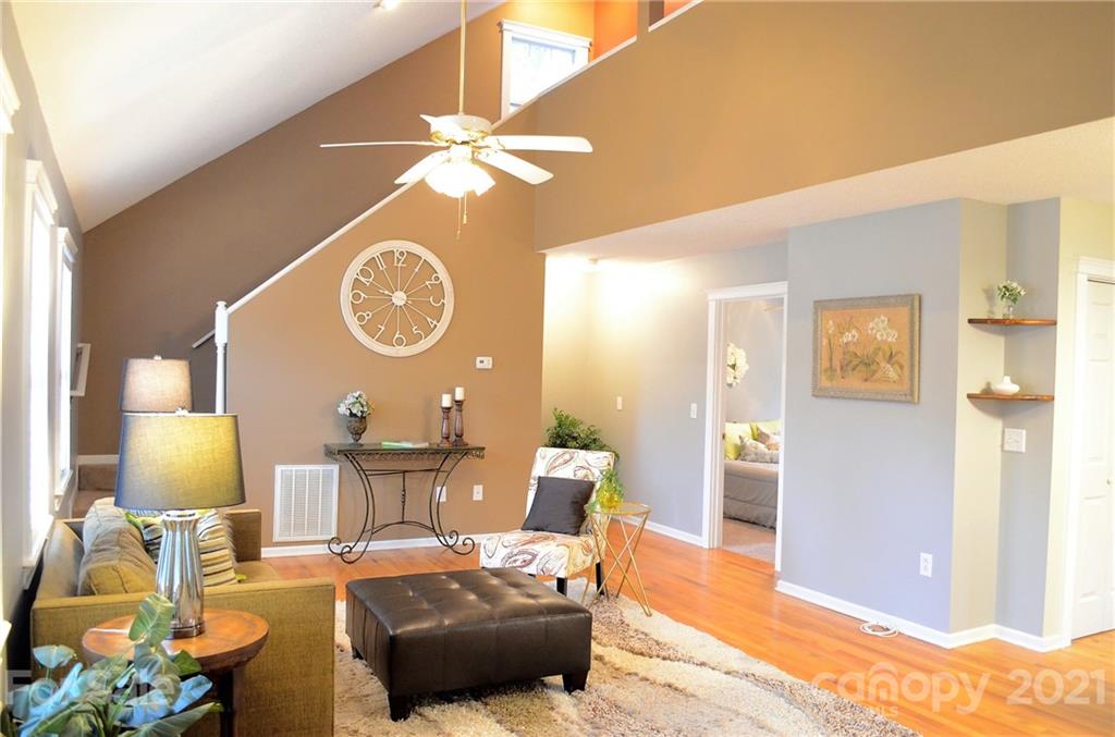 7610 Sarah Drive Denver, NC 28037 - Photo 6 of 48 a living room with furniture a lamp and a window