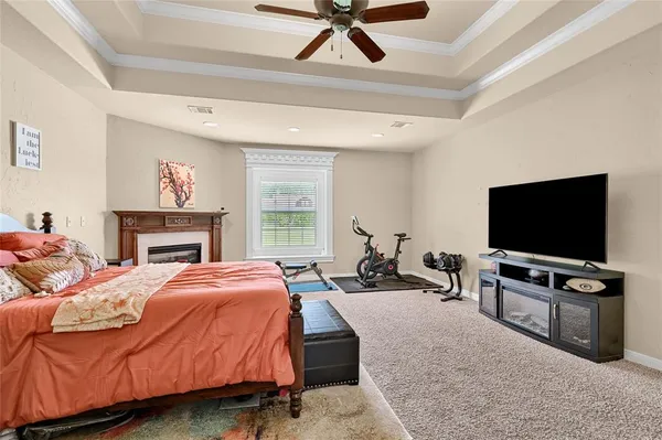 a bedroom with bed tv and window