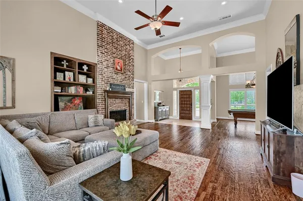 a living room with fireplace furniture and a flat screen tv