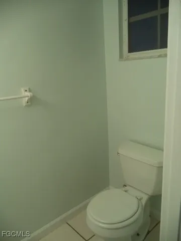 an empty room with a ceiling fan and carpet