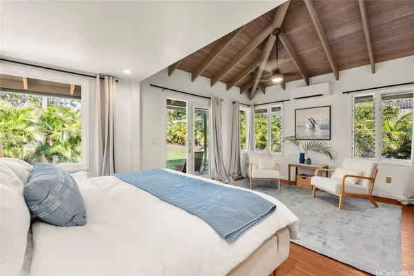 a bedroom with a large bed and a window