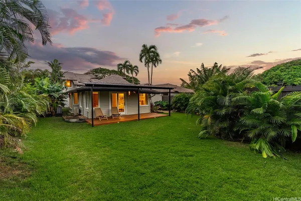 a view of a house with a backyard