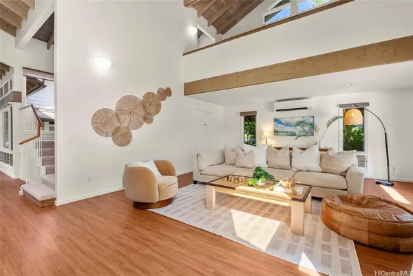 a living room with furniture and wooden floor