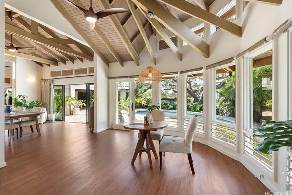 a view of a dining room with furniture window and wooden floor