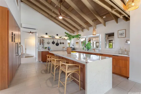 a dining room with furniture and a floor to ceiling window
